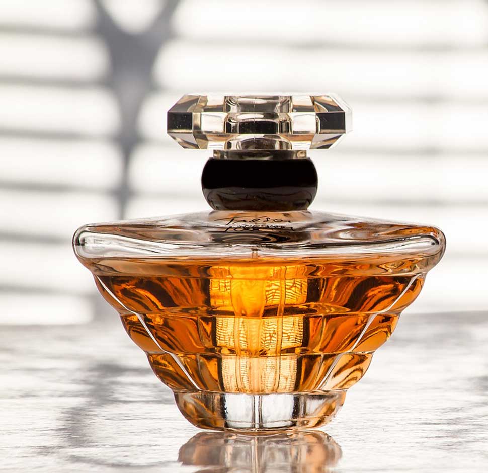 A bottle of perfume sitting on top of a table.