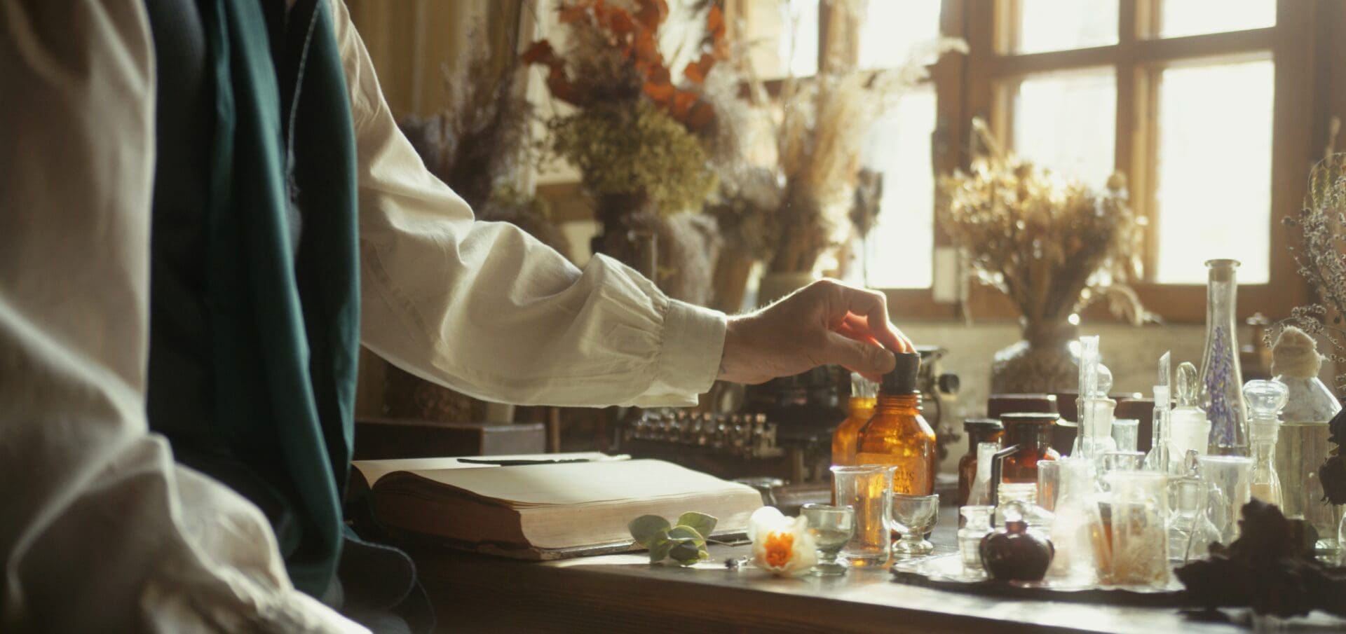 A person is putting something in a glass