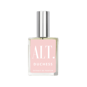 A bottle of pink perfume on top of green background.