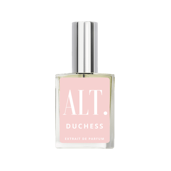 A bottle of pink perfume on top of green background.