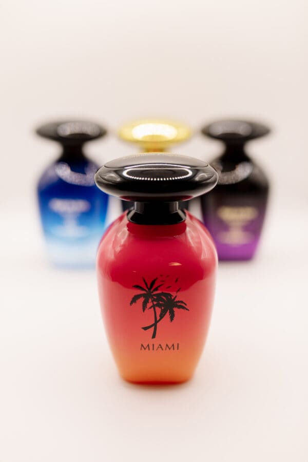 Colorful perfume bottles with palm tree designs.