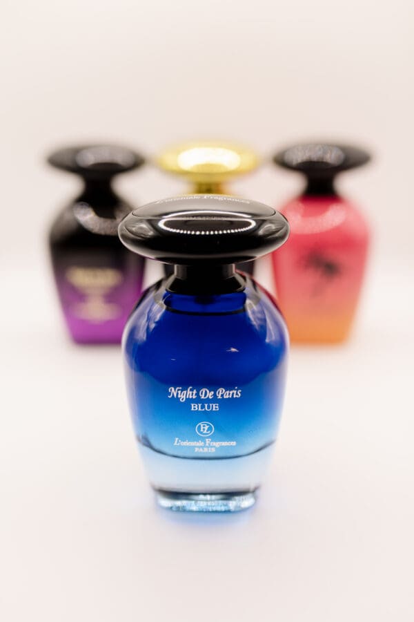 Blue perfume bottle with other fragrances behind.