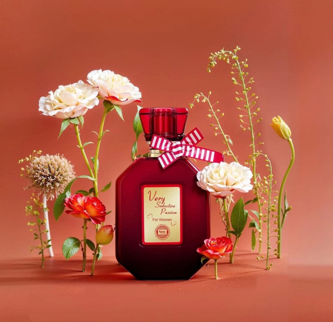Red perfume bottle with assorted flowers.